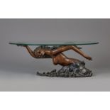 A bronze mermaid coffee table with oval glass top, 20th C.