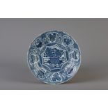 A Chinese blue and white plate with flowers and antiquities, Wanli