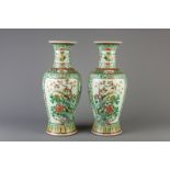 A pair of Chinese famille verte vases with various birds on and near blossoming branches, 19th C.