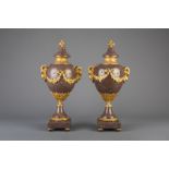 An imposing pair of gilt bronze mounted red porphyry marble cassolettes, 19th/20th C.