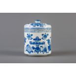 A Chinese blue and white round box and cover with antiquities and flowers, Kangxi