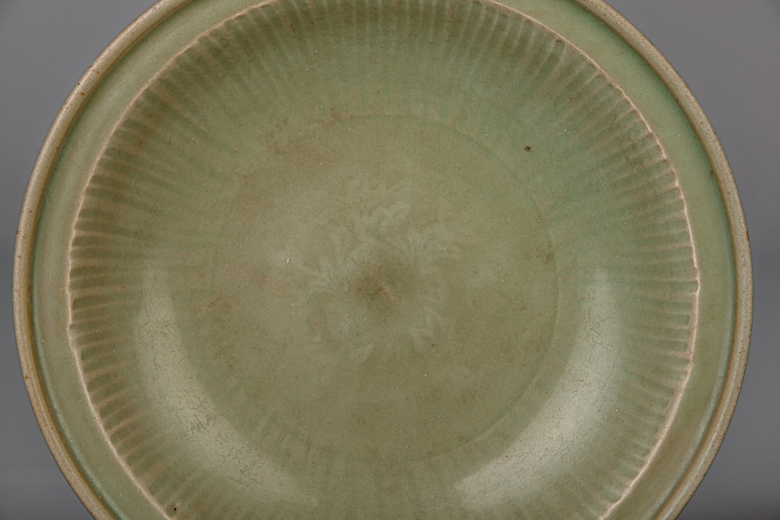 A Chinese Longquan celadon dish with floral underglaze design, Ming - Image 2 of 3