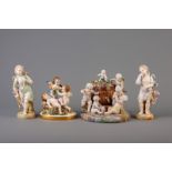 Two groups with putti, one with Sitzendorf mark & two figures in Saxon porcelain, 20th C.
