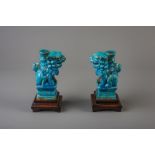 A pair of Chinese turquoise glazed models of Buddhist lions, Ming