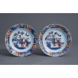 A pair of Chinese Imari style plates with figures in a garden, Kangxi/Yongzheng