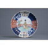 A fine Chinese verte-Imari plate with a lady in a garden, Kangxi