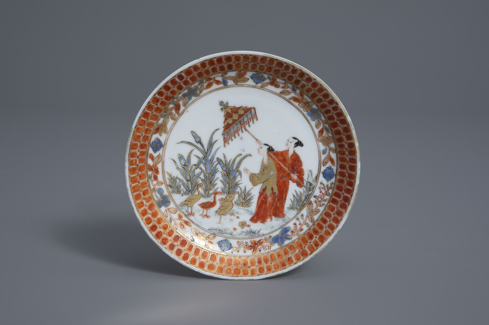 A Chinese Imari export saucer with 'Dames au Parasol' after Cornelis Pronk, Qianlong