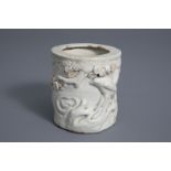 A Chinese monochrome crackle glazed relief decorated brush pot, 19th C.