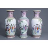 A pair of Chinese famille rose vases and a baluster vase with ladies in a garden, 20th C.
