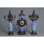 A Chinese three-piece bronze mounted blue and white porcelain garniture, 19th C.