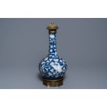 A Chinese blue ground slip decorated bronze mounted bottle vase, 19th C.