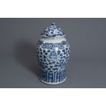 A Chinese blue and white vase and cover with floral design, 19th C.