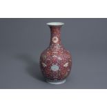 A Chinese famille rose red ground bottle vase, Qianlong mark, 19th/20th C.