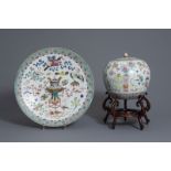 A Chinese famille rose covered jar and a dish with antiquities design, 19th C.