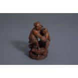 A Chinese carved bamboo group of two boys making merry, 19th C.