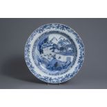 A large Chinese blue and white charger with figures in a landscape, Qianlong