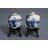 A pair of Chinese blue and white jars with figures in a garden, Kangxi mark, 19th/20th C.