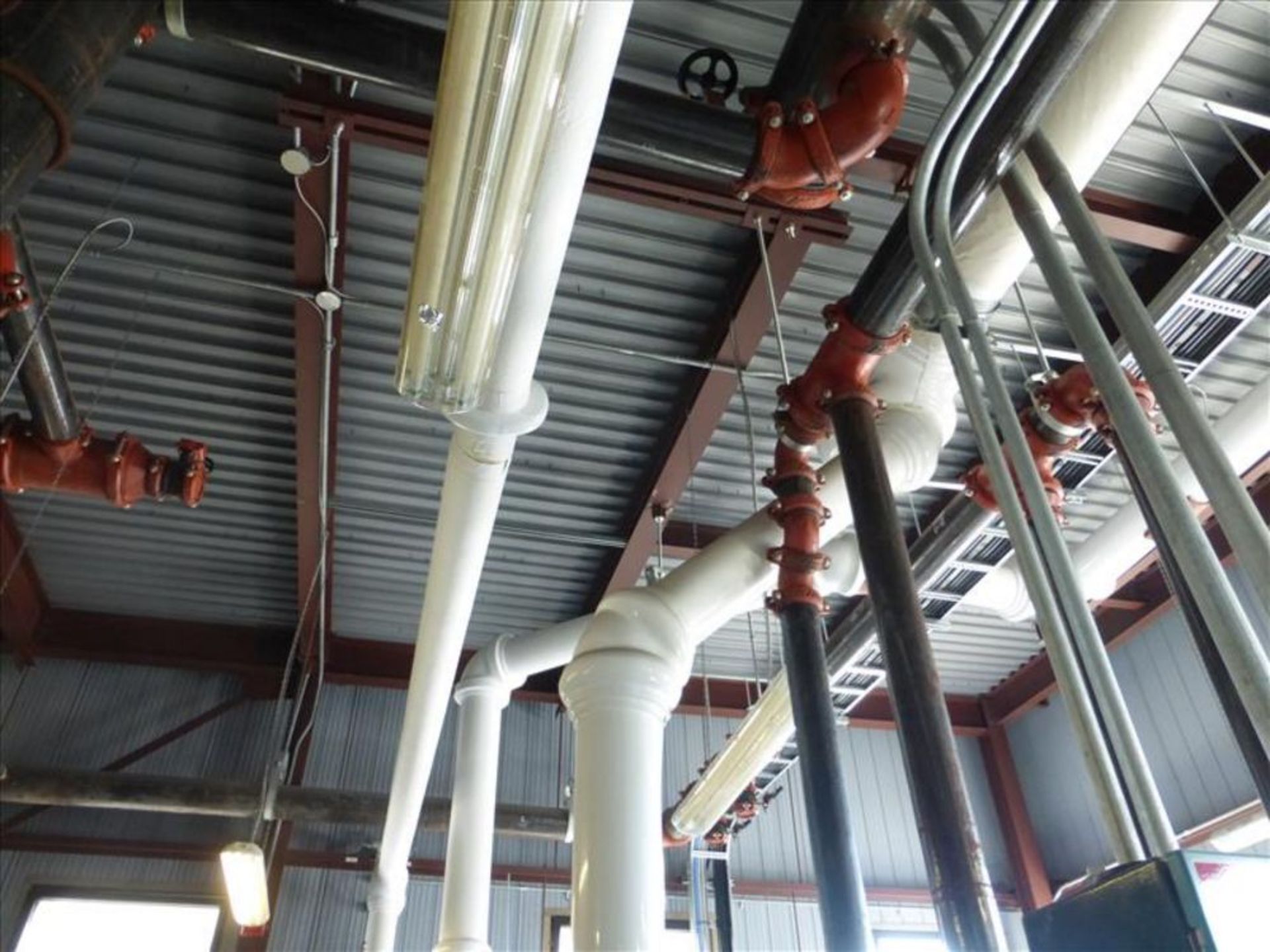 various steel process piping within building including victaulic elbows, connectors, valves,