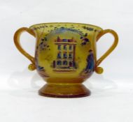 Yellow glass twin-handled vase on footed base, the body decorated with transfer-printed scenes