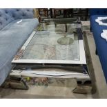 Contemporary designer stainless steel coffee table with inset plate glass top and raised on scroll