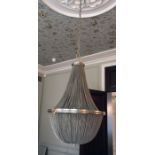 Six-light pear-shaped traditional style chandelier encased in chain link