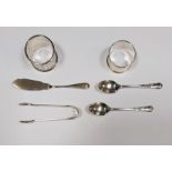 Two silver napkin rings, two silver teaspoons, a silver butter knife and pair silver sugar nips