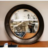 Circular wall mirror with bevelled plate, within a mottled metal frame, diameter 88cm (VAT payable