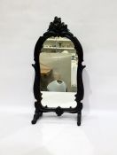 Early 20th Century dressing table mirror with shaped frame surmounted by carved floral spray