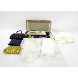 Two lady's evening bags, assorted embroidered tablecloths and a box of embroidery wool