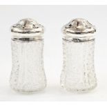 Pair of cut glass and silver-mounted sugar shakers, Birmingham 1904/5, maker's mark 'AG', 12cm high,