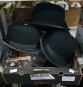 Five bowler hats and stands to include examples by Moores, Christys London