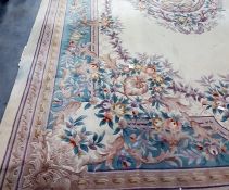 Large Chinese superwash cream ground carpet, the central stepped foliate decorated medallion on a