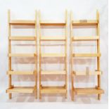 Three beech standing wall shelves of tapering ladder design, of five shelves each, height 190cm (