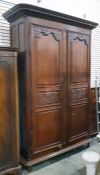 19th century French oak armoire with straight moulded pediment, the pair of scroll carved panel