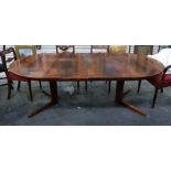 1960's/70's rosewood extending dining table on circular cruciform base, with cross-banded border and