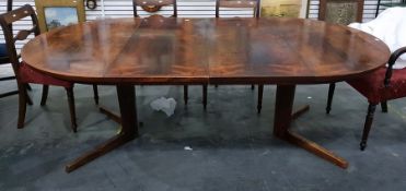 1960's/70's rosewood extending dining table on circular cruciform base, with cross-banded border and