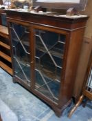 Mahogany Chippendale style glazed bookcase with dentil cornice, the astragal-glazed doors