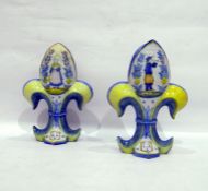 Pair of H R Quimper 'Fleur De Lys' shaped vases, each decorated with Petit Breton of male playing