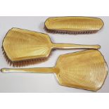 Silver and enamel dressing table set of three pieces, viz:- hand mirror, hairbrush and clothes