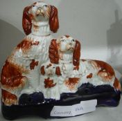 Staffordshire flatback figural group of three Spaniels