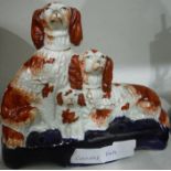 Staffordshire flatback figural group of three Spaniels