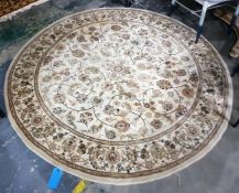 20th century Persian style wool rug, circular, the cream ground with scrolling stylised floral