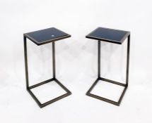 Pair of metal and black glass wine tables of modern oxidised metal frames and an adjustable