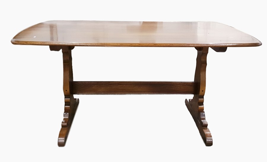 Modern Ercol elm refectory style table with rounded corners, on twin pedestal supports with