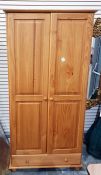 Modern pine wardrobe, the pair of fielded panelled doors enclosing hanging space, long drawer below,