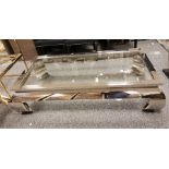 LOT WITHDRAWN Rectangular glass top coffee table with chrome steel frame, raised on short curved