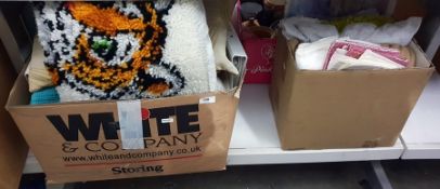 Two boxes of assorted textiles to include various cushions, etc