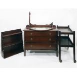 Stained oak chest of three long drawers, a two-tier oak tea trolley, a three-shelf wall rack and