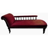 Late Victorian chaise longue with deep red upholstery, the scroll back with turned spindle