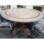 After the antique, a bleached walnut circular pedestal dining table, the top with inlaid and